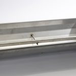 Stainless steel pig trough with a fenced edge and a special stainless steel tube
